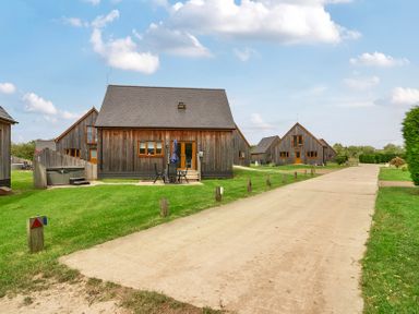 An outdoor area with wooden houses and a path at Lodge 4 near Brigg
