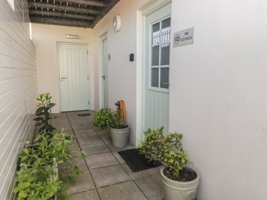 An outdoor entryway with doors and planters at The Bolthole in Newport