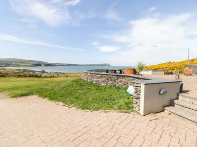 An outdoor area with a stone wall and sea view at The Bolthole in Newport