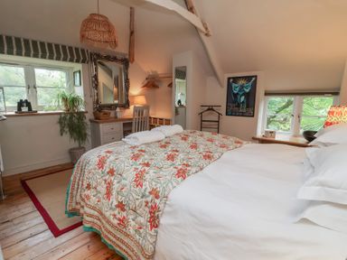 A bedroom with a bed and desk at The Bothy at Lewis Cottage in Spreyton