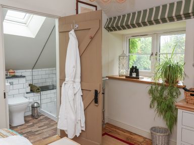 A bathroom with a toilet and sink at The Bothy at Lewis Cottage in Spreyton