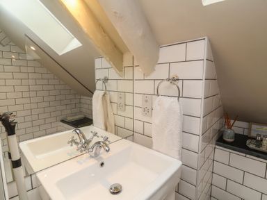 A bathroom with two sinks and towels at The Bothy at Lewis Cottage in Spreyton