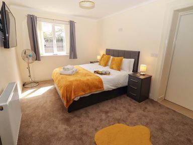 A bedroom with a double bed and bedside tables at Willow cottage in Seahouses