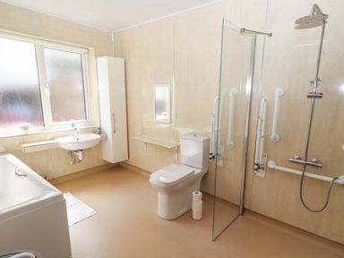 A bathroom with a bathtub, shower, sink, and toilet at Willow cottage in Seahouses