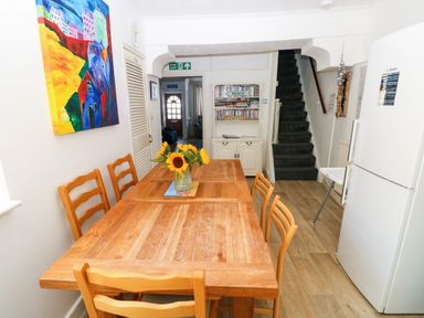 A dining room with a table and chairs at 3 Edward Street Tenby