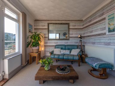 A living room with a sofa and coffee table at 1 Bed Flat - Sleeps 2 - Pets - Balcony - Parking in Looe