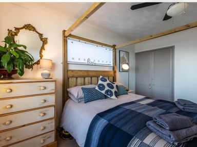 A bedroom with a bed and bedside lamp at 1 Bed Flat - Sleeps 2 - Pets - Balcony - Parking in Looe