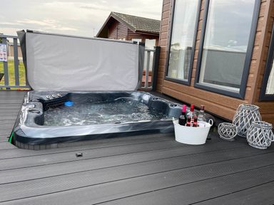 A hot tub with a bucket of drinks at Yorkshire view lodge Wilberfoss