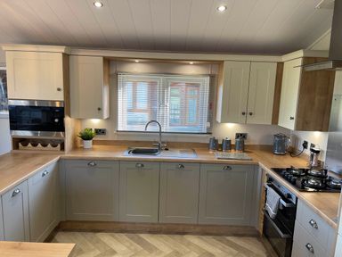A kitchen with cabinets and appliances at Yorkshire view lodge in Wilberfoss