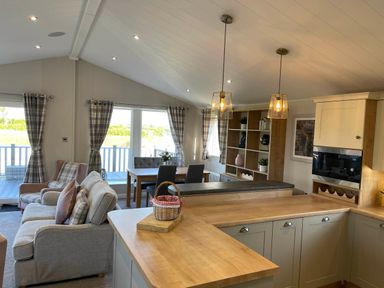 A living room with a sofa and dining table at Yorkshire view lodge in Wilberfoss