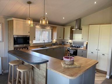 A kitchen with appliances and an island at Yorkshire view lodge in Wilberfoss