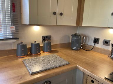 A kitchen with canisters and kettle at Yorkshire View Lodge in Wilberfoss