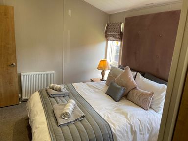 A bedroom with a bed and lamp at Yorkshire view lodge in Wilberfoss