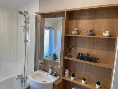 A bathroom with a shower bathtub and sink at Yorkshire view lodge Wilberfoss