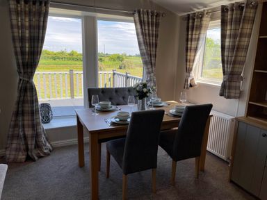 A dining room with a table and chairs at Yorkshire view lodge in Wilberfoss