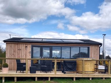 An outdoor area with a cabin and hot tub at Cleeves Cabins 2, Arran Luxury Lodge with hot tub, St. John's Town Of Dalry