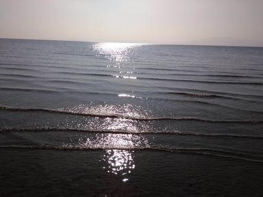 A view of the sea with sunlight reflecting on the water surface