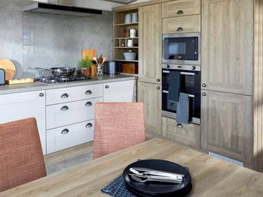 A kitchen with stove, oven, cabinets and dining table at 2 Bed Lodge Sleeps 4 - Pet Welcome - Fireplace, Cirencester