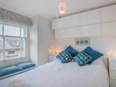 A bedroom with a bed and bedside tables at Sedbergh Penthouse - KingBed - Tv - Wifi Sedbergh