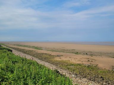 A beach with sand and water at Beachside Lodge - Sleeps 6 - Pets ok - Parking in Heysham