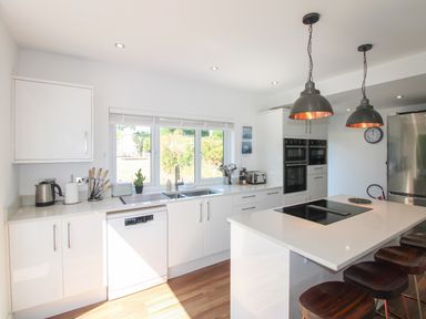 A kitchen with a sink and appliances at Lorrell in Salcombe