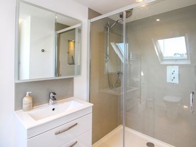 A bathroom with a sink and shower at Lorrell in Salcombe