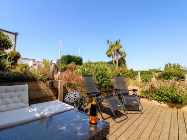 An outdoor space with a couch and table at Lorrell in Salcombe