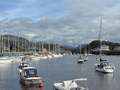 A harbor with multiple boats at 10 Oakley Wharf Porthmadog