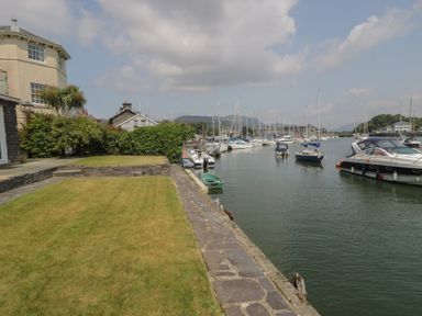 A view of the marina with boats and grass at Harbourside in Porthmadog