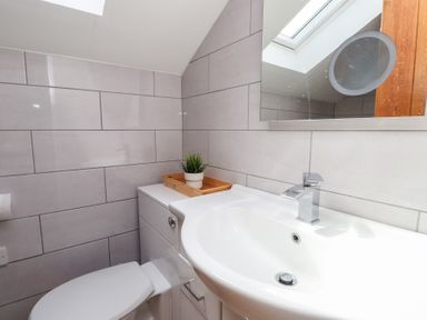 A bathroom with a sink and toilet at Kiloran in Rhosneigr