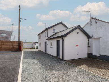 A house exterior with a pathway at Kiloran Rhosneigr