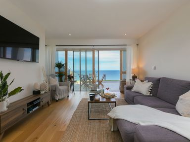 A living room with a sofa and coffee table at Anchors Rest in St. Ives