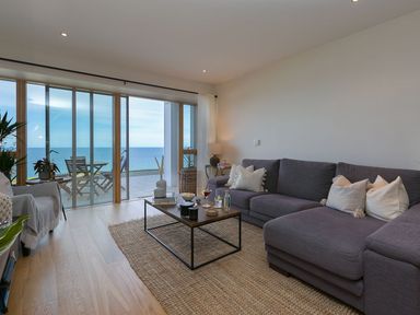 A living room with a sofa and coffee table at Anchors Rest in St. Ives