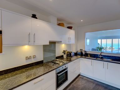 A kitchen with cabinets and appliances at Anchors Rest in St. Ives