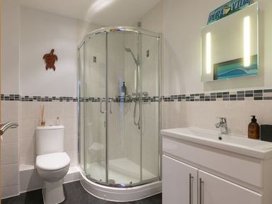A bathroom with a shower, toilet, and sink at Anchors Rest in St. Ives