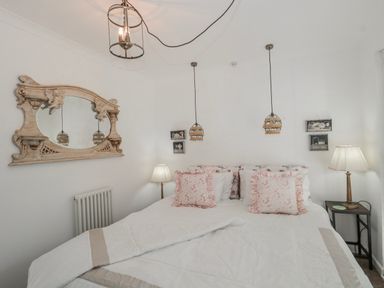 A bedroom with a bed and lamp at 7 The Cedars in Wotton-Under-Edge