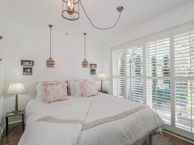 A bedroom with a bed and lamps at 7 The Cedars in Wotton-Under-Edge