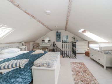 A bedroom with a bed and a dresser at 7 The Cedars in Wotton-Under-Edge