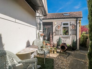 A garden with gravel path and seating area at 7 The Cedars Wotton-Under-Edge