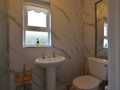 A bathroom featuring a sink and toilet at An Grianan Getaway in Burt