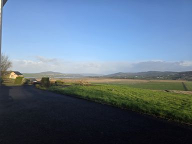 A view of fields and hills from a property at An Grianan Getaway in Burt