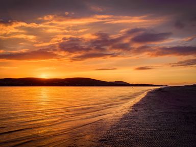 A scenic view of sunset over water at An Grianan Getaway in Burt