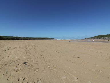 A beach with sand and water at Shamrocks Cove Caravan