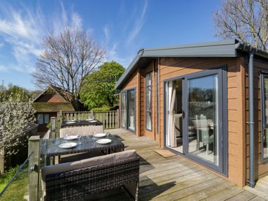 An outdoor area with a table and chairs at Borwick Heights 17 in Carnforth