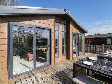 An outdoor space with a table and chairs at Borwick Heights 17 Carnforth