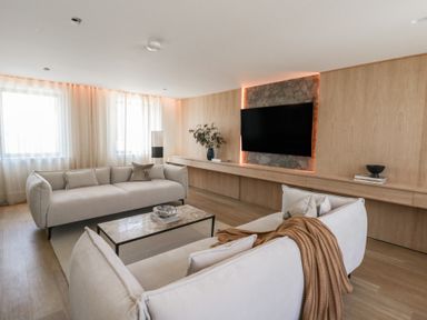 A living room with sofas and a television at Brynseion Uchaf near Aberystwyth