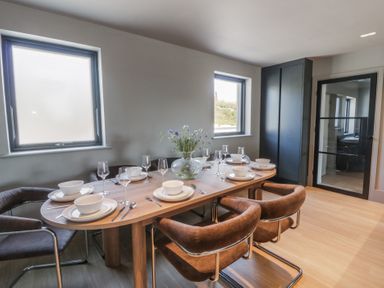 A dining room with a table set for a meal at Brynseion Uchaf near Aberystwyth