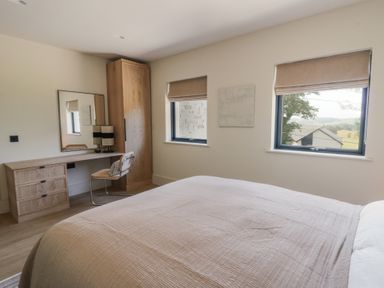 A bedroom with a bed and desk at Brynseion Uchaf near Aberystwyth