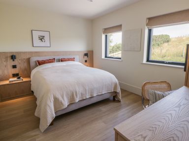 A bedroom with a bed and a desk at Brynseion Uchaf near Aberystwyth