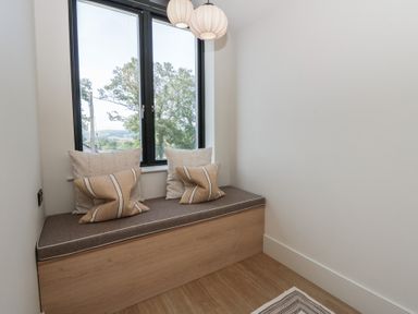 A snug with a window seat and cushions at Brynseion Uchaf near Aberystwyth